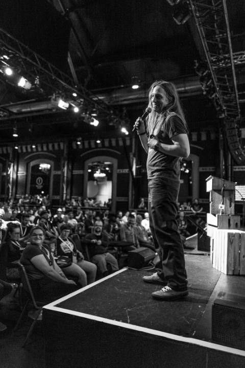 Marc on stage during his good-bye-speech. He is laughing and talking to someone off stage.