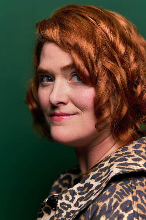 Portrait of Amber Case in front of a green background.