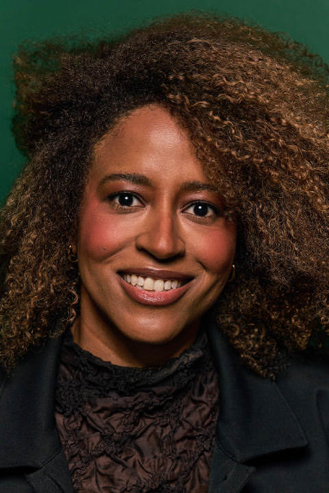 Portrait of Sharon Steed in front of a green background.