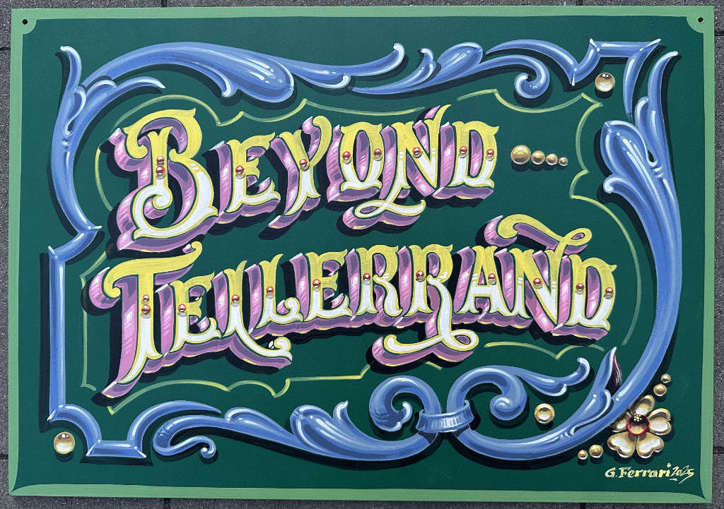 A hand-painted sign by Gustavo Ferrari. The background is green. In beautiful letters it says “beyond tellerrand” in yellow and white with a pink and violett drop shadow. The words are surrounded by a blue floral frame. Everything has beautiful and amazing details.