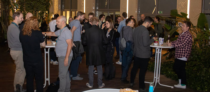 Photo with attendees of the warm-up. People chatting and networking.