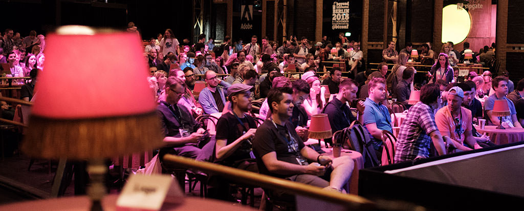 Photo showing the typical lamp of Düsseldorf’s event and attendees sitting in the audience