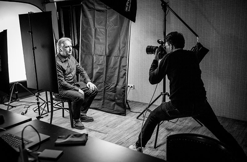 A photo of Norman in an action pose to shoot a photo of Jeremy Keith