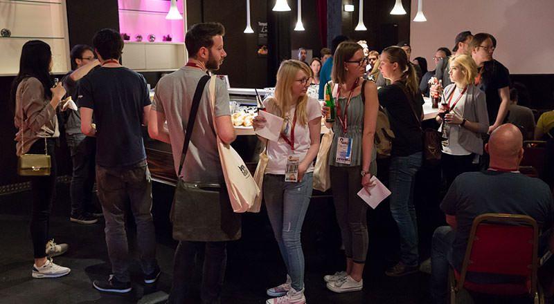 Photo with people queueing for the Lunch-Time Session snacks