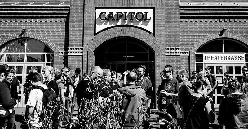 Photo showing attendees outside in the sunshine during the event break