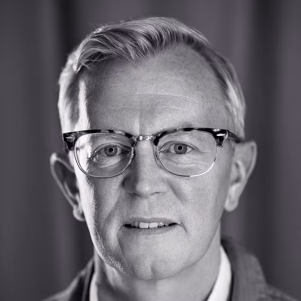 A portrait photo of Aarron Walter who looks straight into the camera, gently smiling