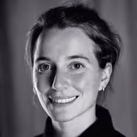 A portrait shot of Katie Menzies. She smiles and looks into the camera